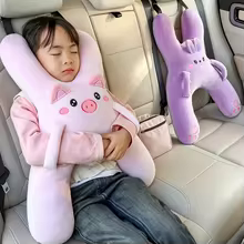Girl sleeping with NapBuddy pink pig travel pillow in the car